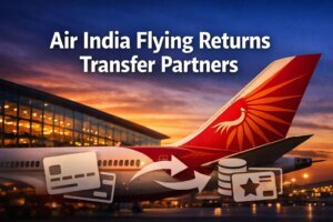 An Air India airplane is parked near a modern airport terminal at sunset, with the text Air India Flying Returns transfer partners above icons of a credit card, coins, arrows, and a reward card.